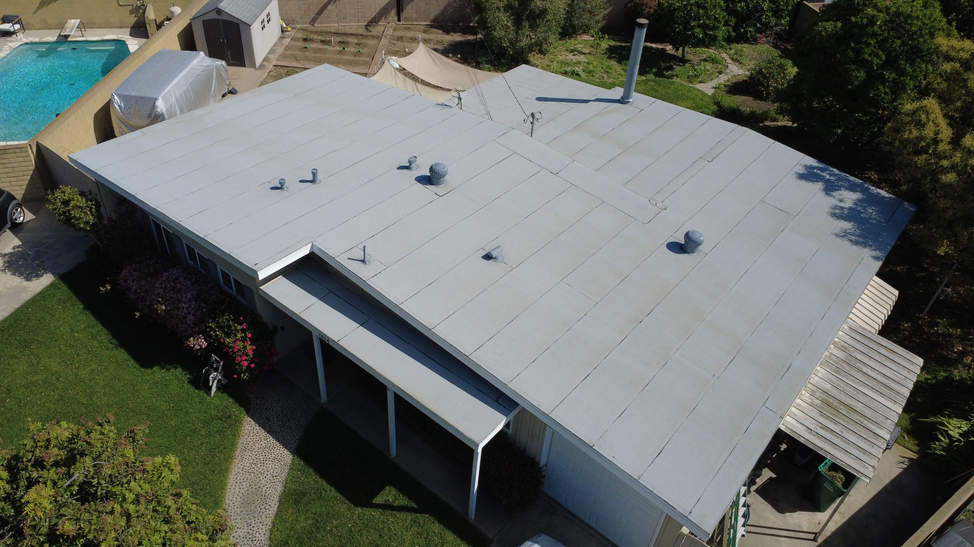 Aerial view of a Southern California home with a flat roof and pool