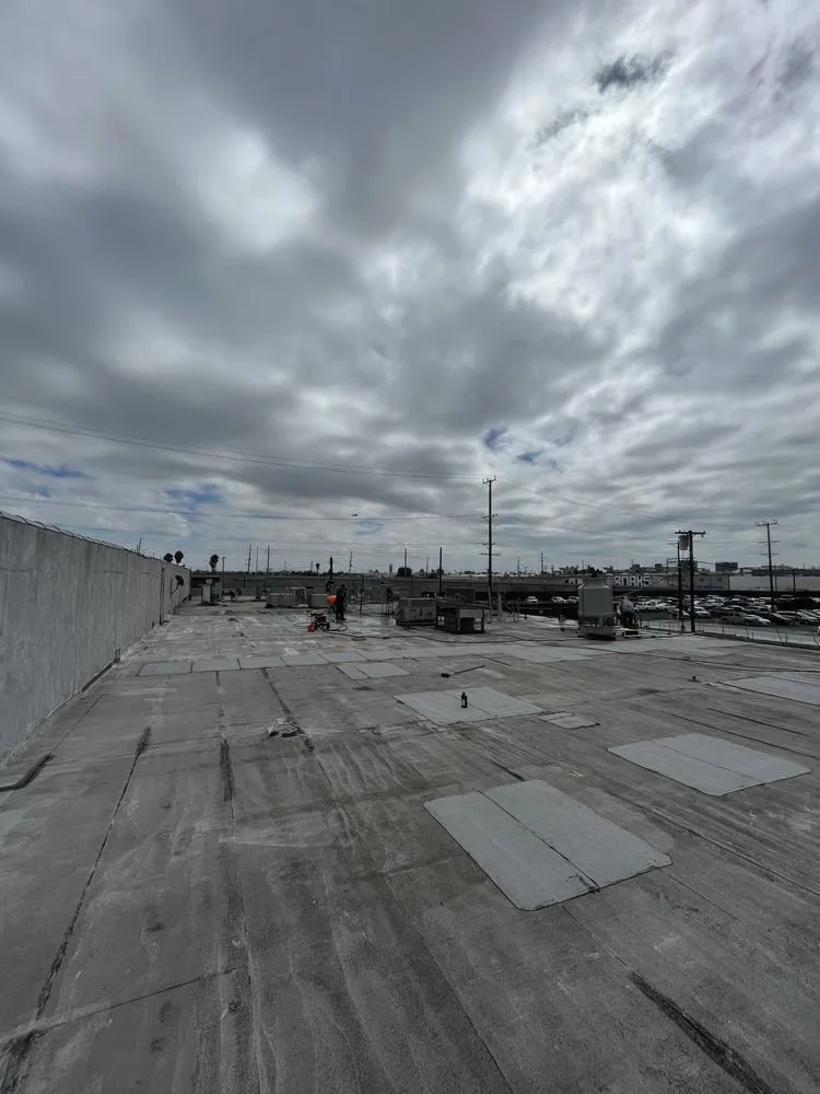 Wide view of a weathered commercial flat roof before coating