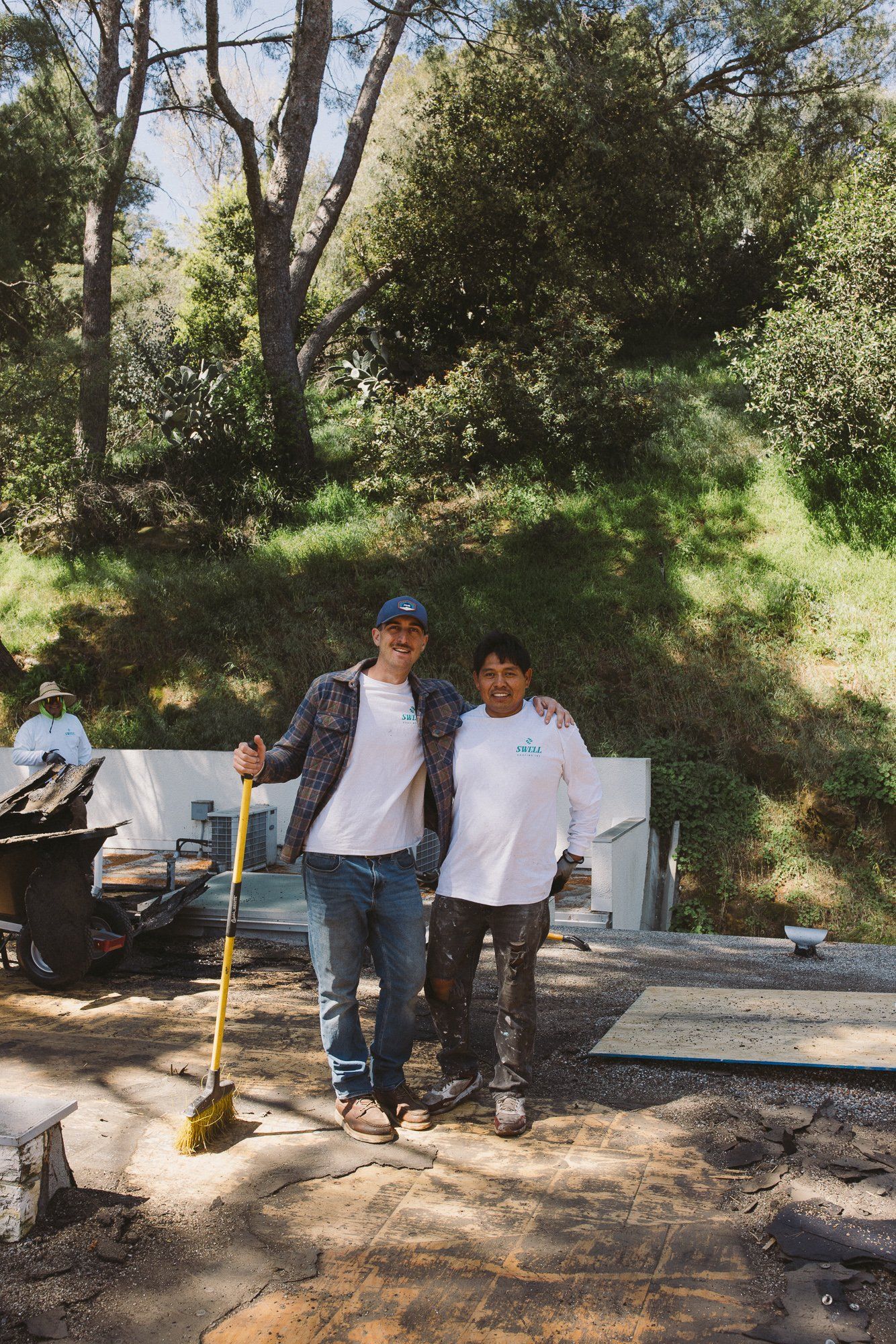 Asa Wolfe with a Swell Roofing crew member at a tear-off site