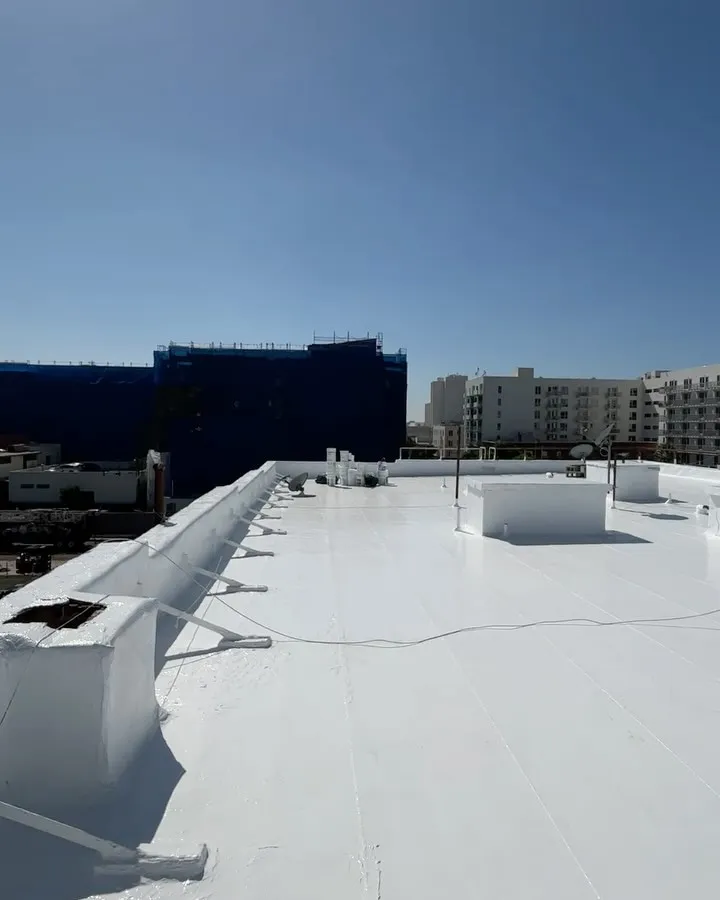 Finished white commercial roof with the Downtown Los Angeles skyline beyond