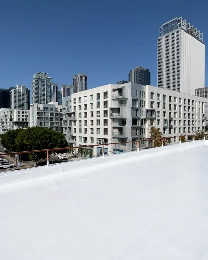 Completed white flat roof against the Downtown Los Angeles skyline