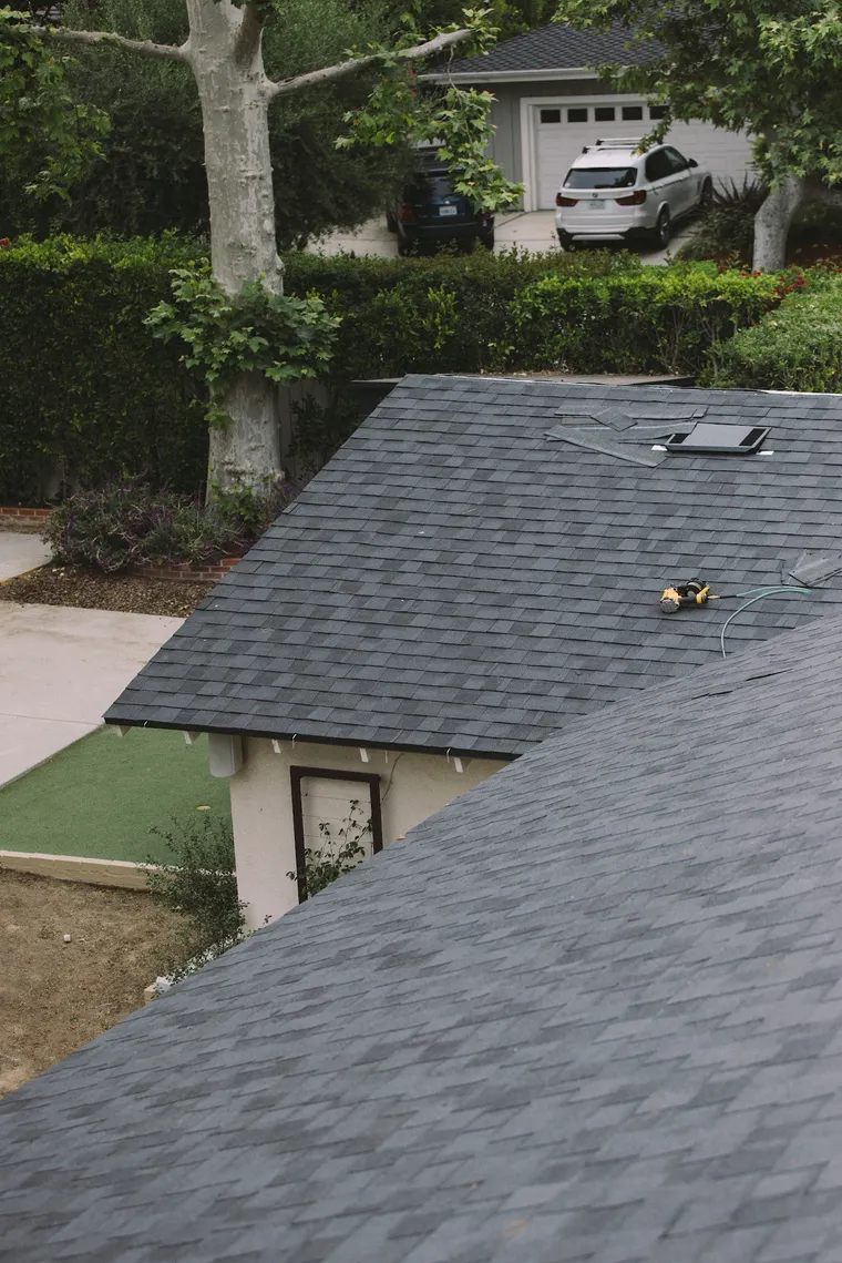 New gray shingle roof viewed from the slope toward the street