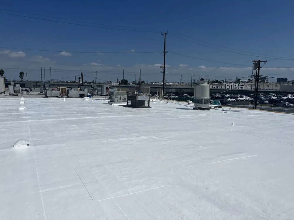 Finished bright white coated flat roof with rooftop equipment