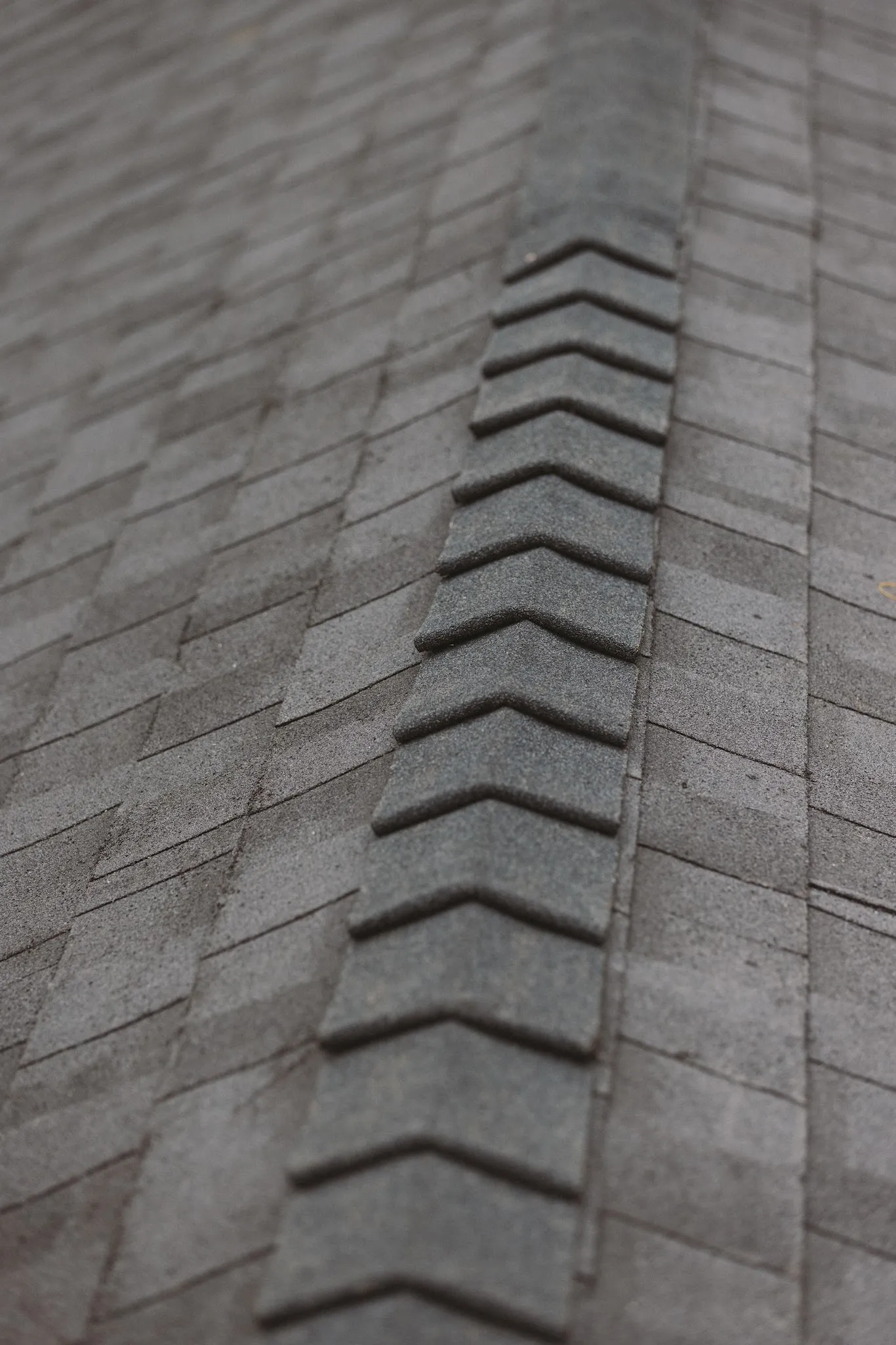 Close view of new ridge-cap shingles along a roof hip