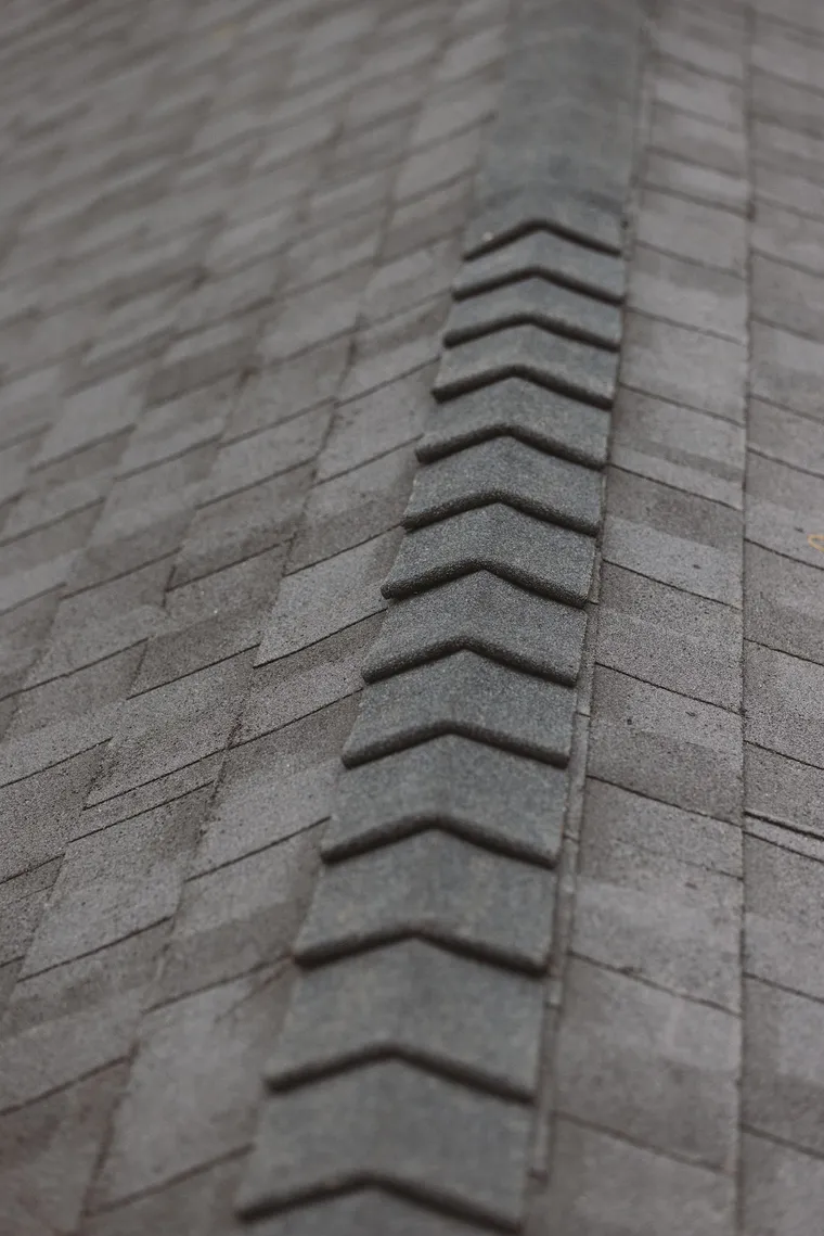 Close view of new ridge-cap shingles along a roof hip