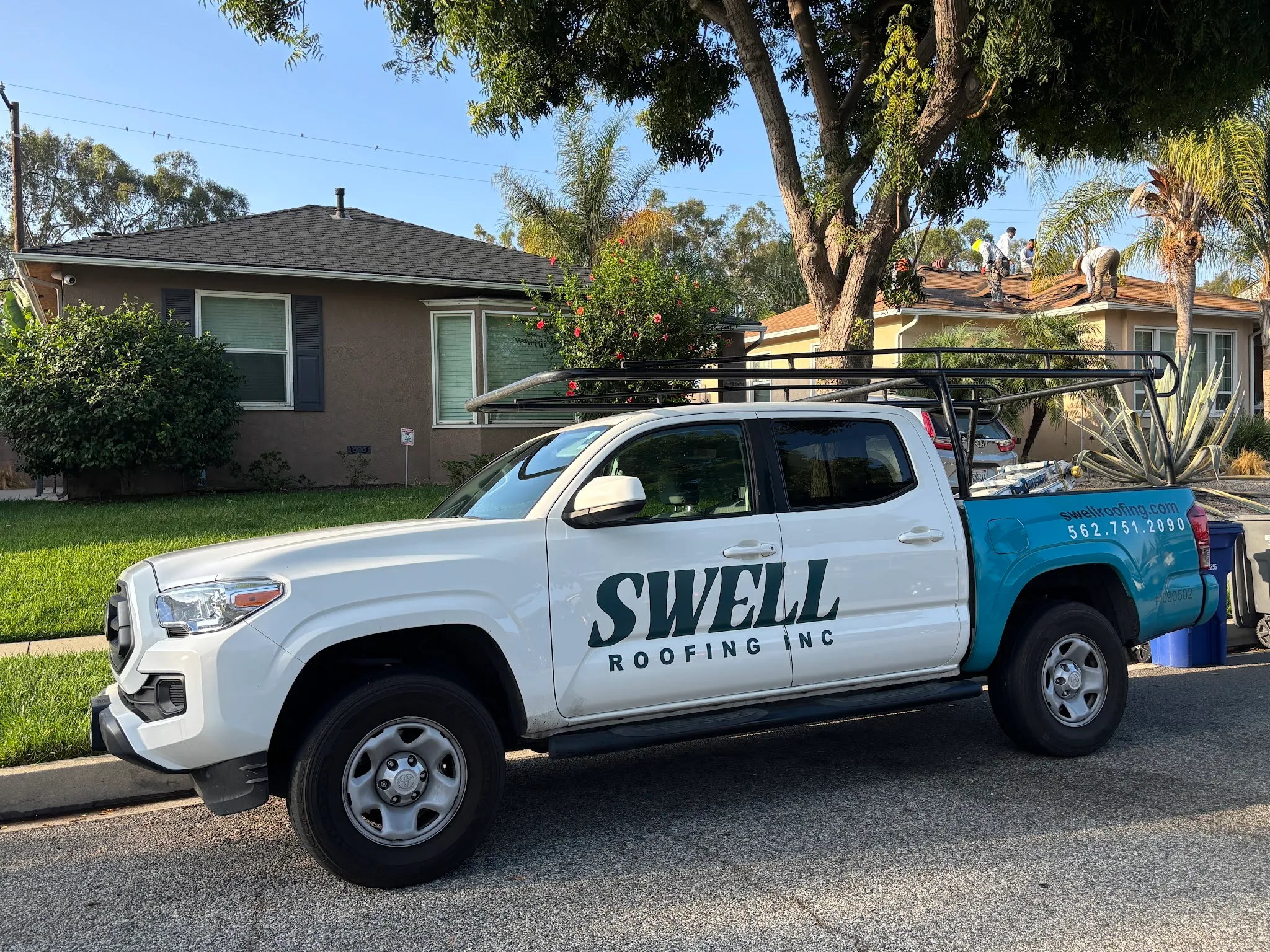 Swell Roofing branded truck with ladder rack