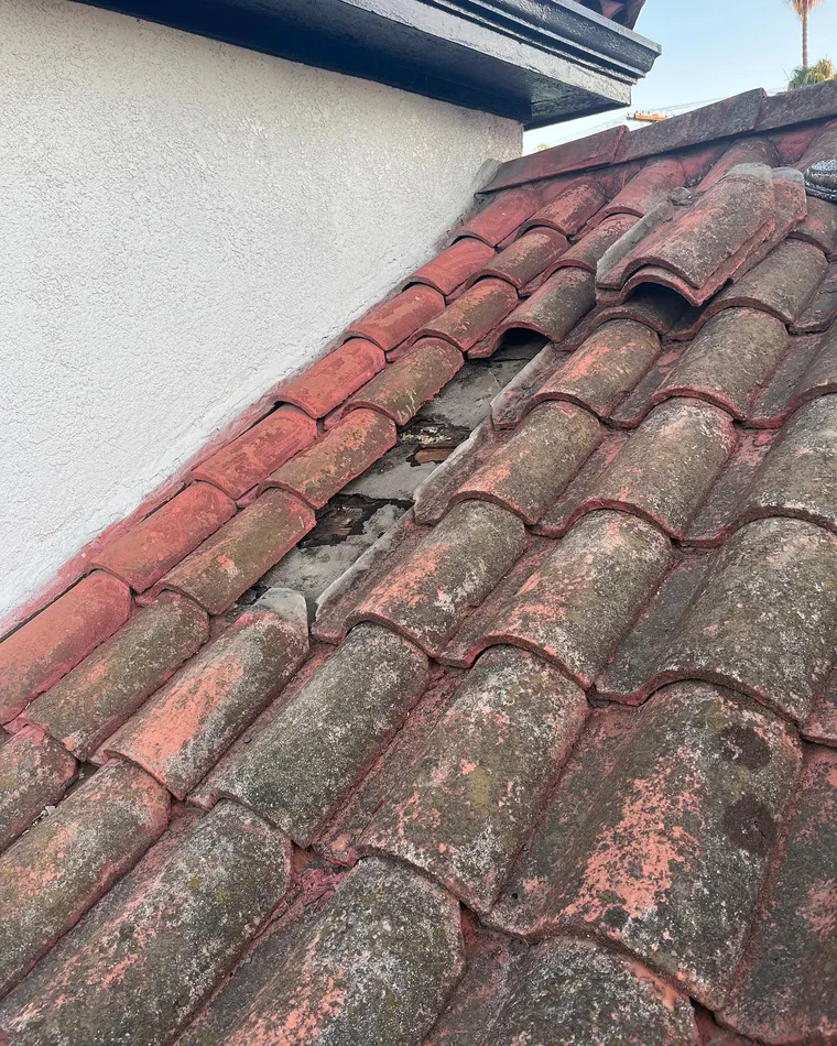 Wide view of slipped clay tiles discovered during a roof inspection