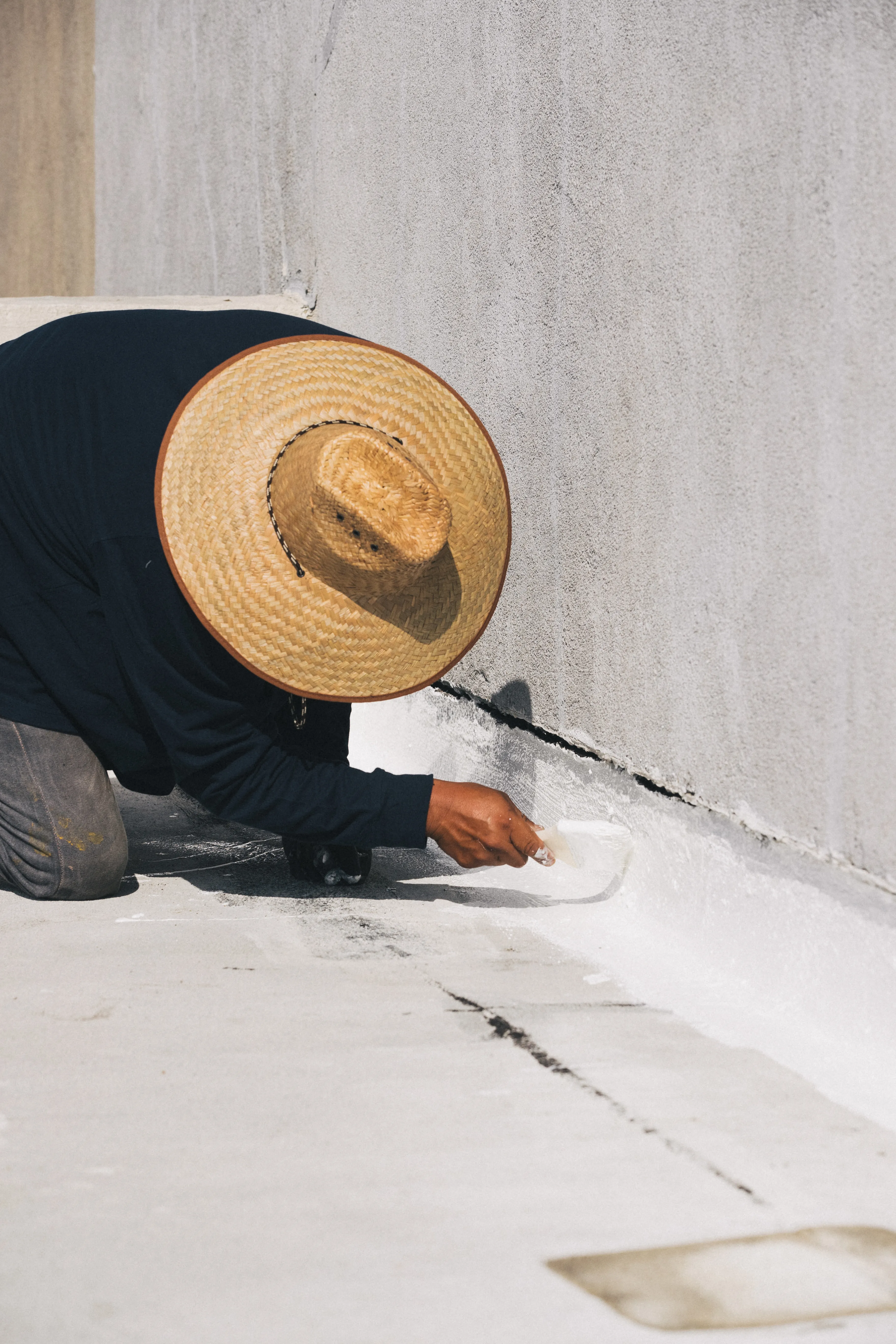 Swell roofer sealing a commercial parapet wall